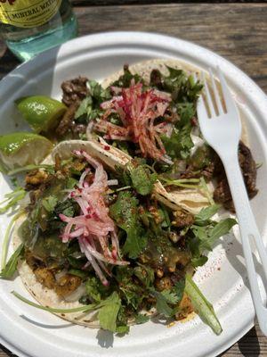 One steak and one veggie taco. The vegetable tacos are made with an array of sautéed, marinated vegetables. (Mine are dairy free).