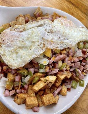 Denver skillet  topped with fried egg over easy