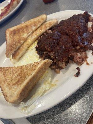 Corned beef hash with eggs over medium and white toast! The hash doesn't look appetizing but it tasted good!