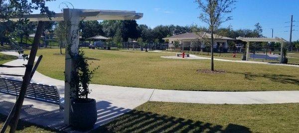 Inside of the medium size dog park, a walking trail ,3 long benches to sit on, fire hydrant that sprays light mist out for your dog.