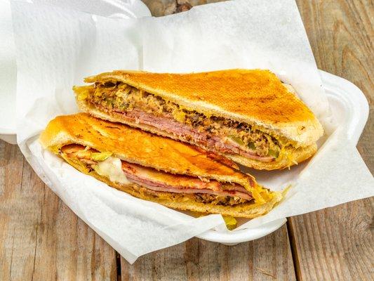 Key West Cuban sandwich with Pulled pork tenderloin, ham, Swiss, dill pickle, and mustard grilled on fresh baked Cuban bread