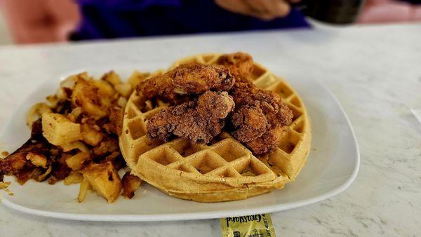 Chicken tenders and waffle with a side of potatoes