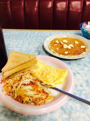 Cheese omelet with hash browns and wheat toast. With a pancake! Yum!