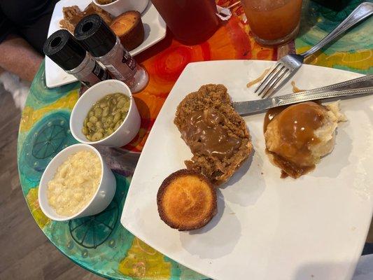 Fried hamburger steak, creamed corn, Lima beans and mashed potatoes.