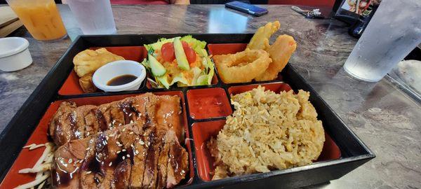 bento w/ soup not pictured ,gyoza, spring roll, house salad w/ ginger dressing, veg tempura, hibachi steak over cabbage, egg fried rice.