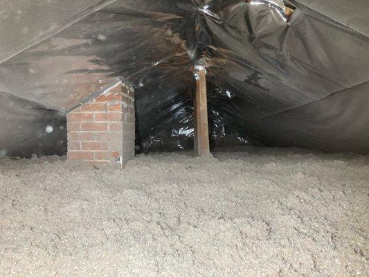 Application of cellulose  material and radiant barrier.  While it can't be seen here, the chimney is protected from the material per code!