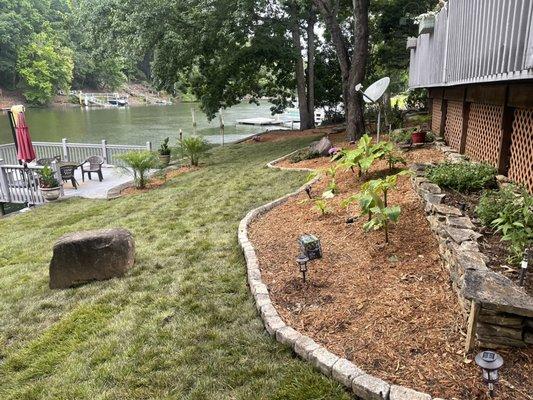 We installed new sod , and brick edging with some new plants and mulch into the beds .