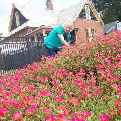 Mary taking time out from selling beads to weed here flowers