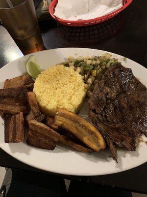 Roast pork, Fried pork, rice, plantains, corn/potato mix and beans on the side!