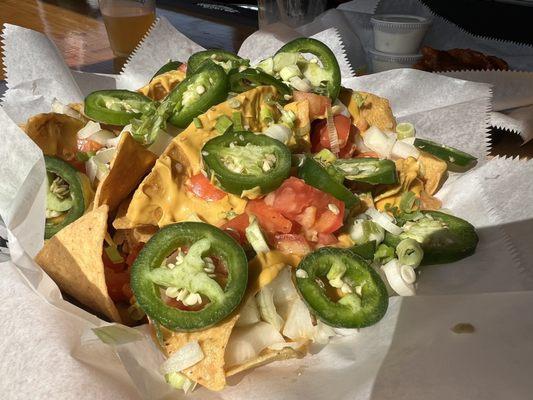 Nachos with hand sliced jalapenos. So much cheese.