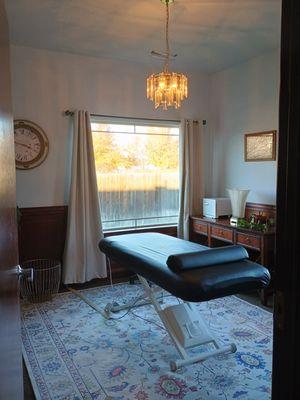 Our treatment room with a heated electric lift table, Wholetones Meditative music with healing frequencies, and only organic supplies used.