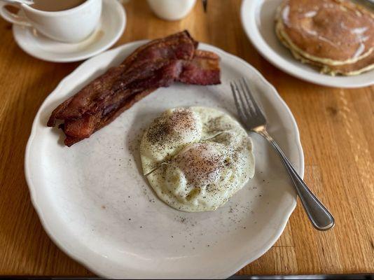 Eggs over medium w/ bacon, pancakes & coffee.