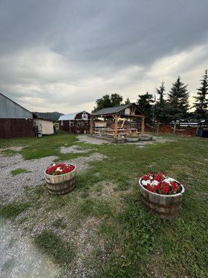 Outside view complete with picnic area, little indoor space and cute geraniums