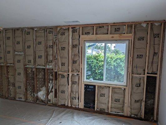 New wood framing and insulation, old air conditioner removed and hole closed