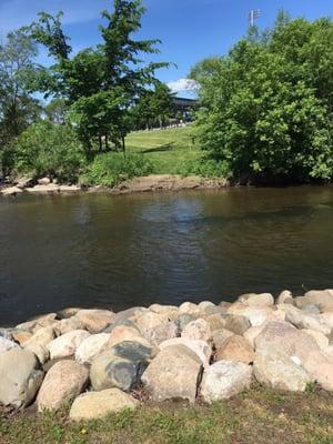 A beautiful sitting area with the Clinton River quietly  flowing along the trail in downtown Utica