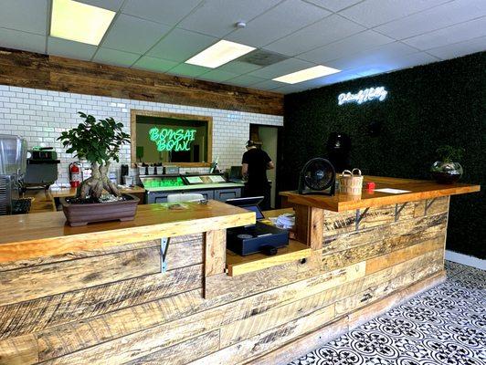 Counter Area with Bonsai Tree and "Deliciously Healthy" Sign