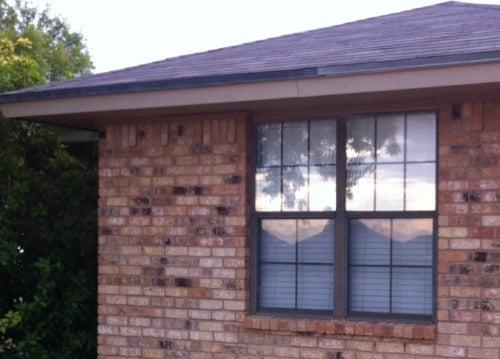 Windows on home BEFORE installation of new double-hung white windows from Window Depot.