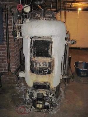 An asbestos covered "snowman" type boiler. These are very common and were built to last.