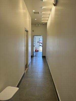 Hallway leading to the bathroom and back parking lot