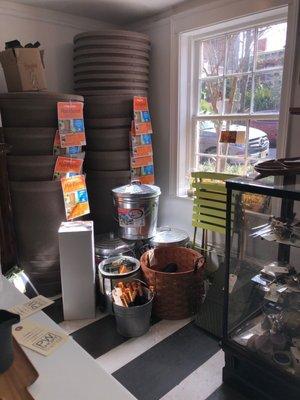 Gardening supplies, display case on right has sterling silver serving, flatware, flask