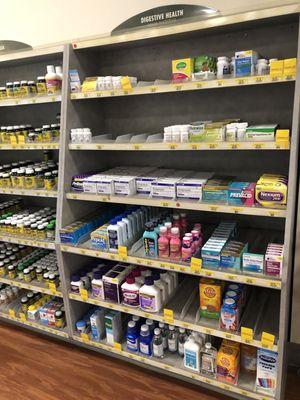 Whole wall of over the counter meds. Most parts had patrons in front looking for meds.