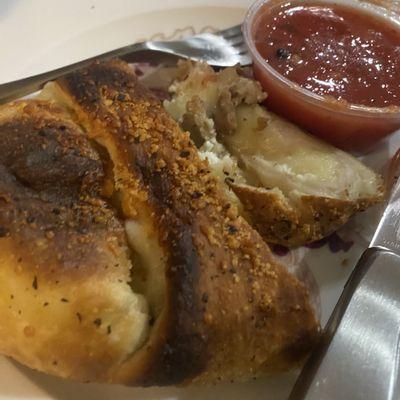 Meatless meatball calzone with red water in a cup