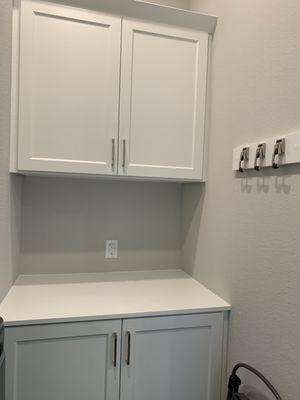 Customized counter and cabinets. Wall hooks as well