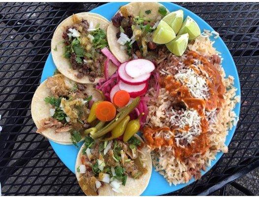 Carnitas, asada and pollo tacos served up with some beans and rice. Yum!