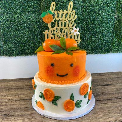 2 tiered Baby Shower cake, cuties themed (clementine brand), all buttercream decorated adorned with fresh fruit on top.