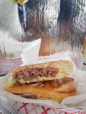 This is the Cuban Sandwich, almost 9 inches filled with pork, ham, cheese, mayo, mustard and pickles.