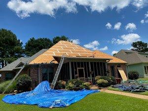 Installing a residential roof in a Village Green Court neighborhood in Jackson