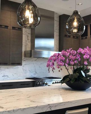 Custom designer glass pendant lights over the kitchen island. 6" & 4" recessed can lights across the ceiling of the kitchen.