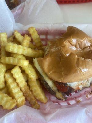 Double hamburger with ketchup and fries.