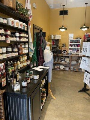 Interior: with display filled with jams, jellies, preserves and more on the left. Along with tasters out for customers to try!