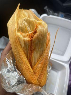 Red chicken tamales with corn husk