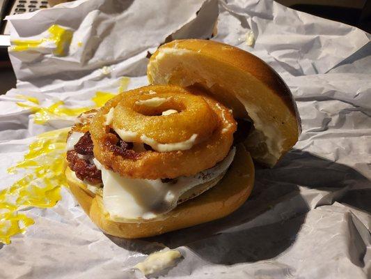 Insane bagel sammie with Hash browns,  sausage,  bacon, cheese, and onion rings on an egg bagel. Cardiologists are now following me around!