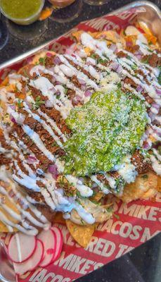 Loaded Nachos w/ birria, queso, beans, cilantro, onions, sour cream, guacamole, & cotija cheese