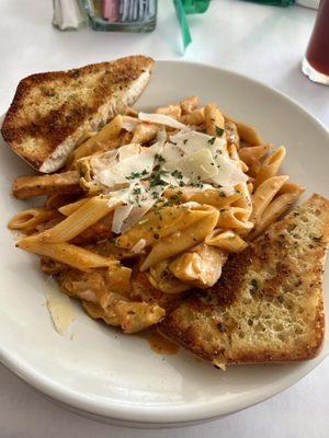 Penne pasta with chicken & artichokes in a light tomato cream sauce.