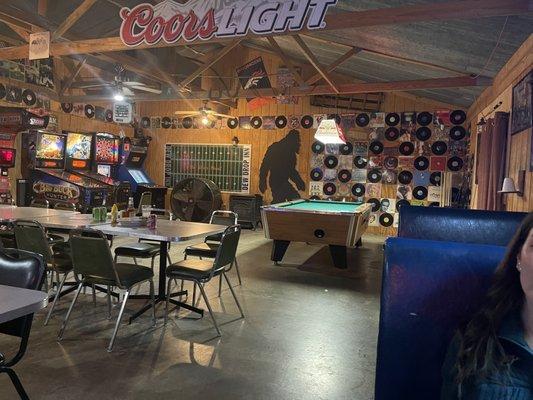 Sweet decor with arcade games, pool, and vinyl records lining the entire wall.