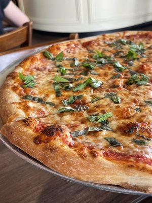 Traditional cheese pizza with fresh basil