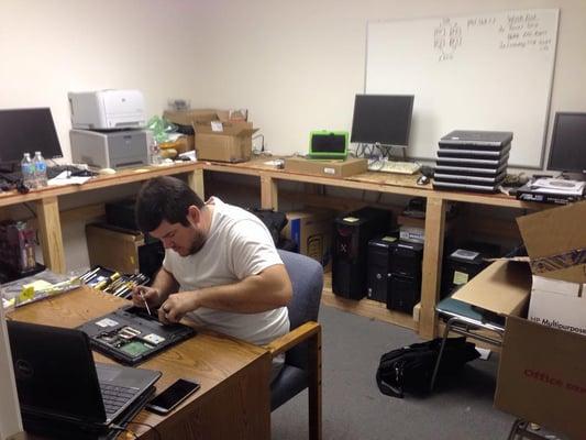 Thomas working on laptop repair.