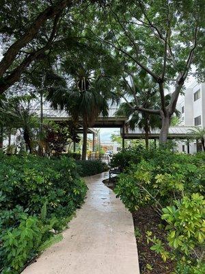 The Solaire At Las Palmas Village exterior with a garden