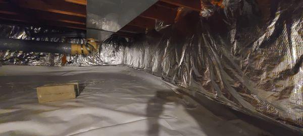 12 mil crawlspace vapor barrier reinforced to 15 mil, and R-19 fiberglass insulation with silver reflective facing on the crawlspace walls