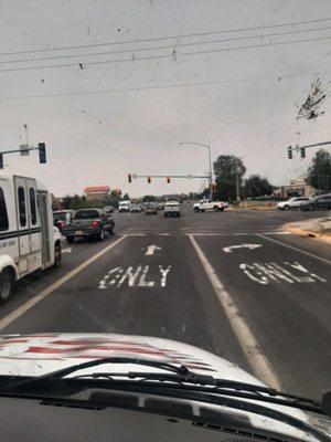 In the intersection the truck with the mattress in back.