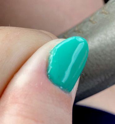 There is a faint vertical line on the left side of my nail (near the bubble alone the left edge). That's the piece of hair.