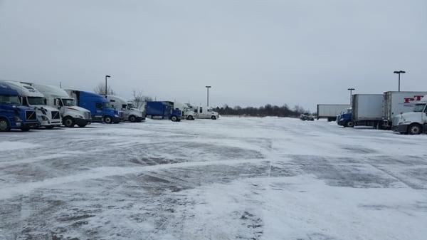 Parking lot uses a small bulldozer to remove snow.