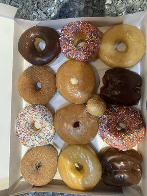 Dozen donuts : chocolate, cinnamon sugar, sprinkle glaze, raspberry filled, vanilla cream, chocolate buttermilk, & glazed donuts