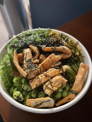 Large salmon/ spicy salmon bowl topped with cucumbers, EDAMAME, seaweed salad, mango, avocado, shredded nori, Furikake, crispy wontons.