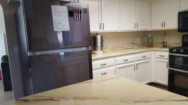 My black stove on the right compared to the wrong color silver fridge.