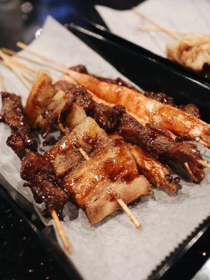 Beef, pork belly, and shrimp skewers